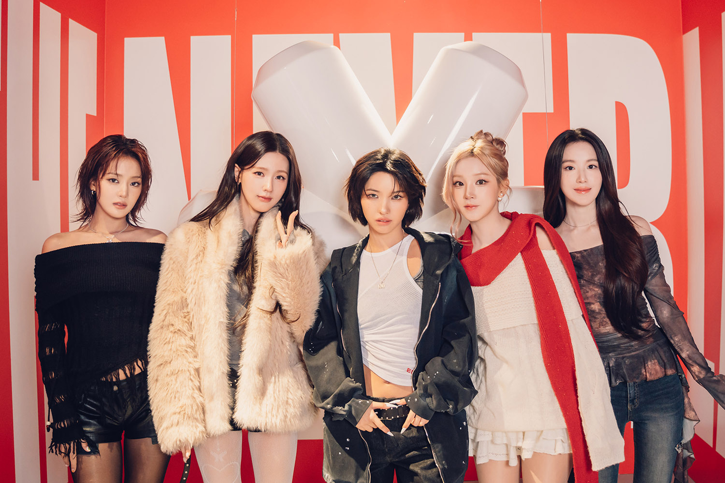i-dle members pose for a photo in front of a media exhibition on the girl group, titled ″City of Sense,″ in eastern Seoul. [CUBE ENTERTAINMENT]