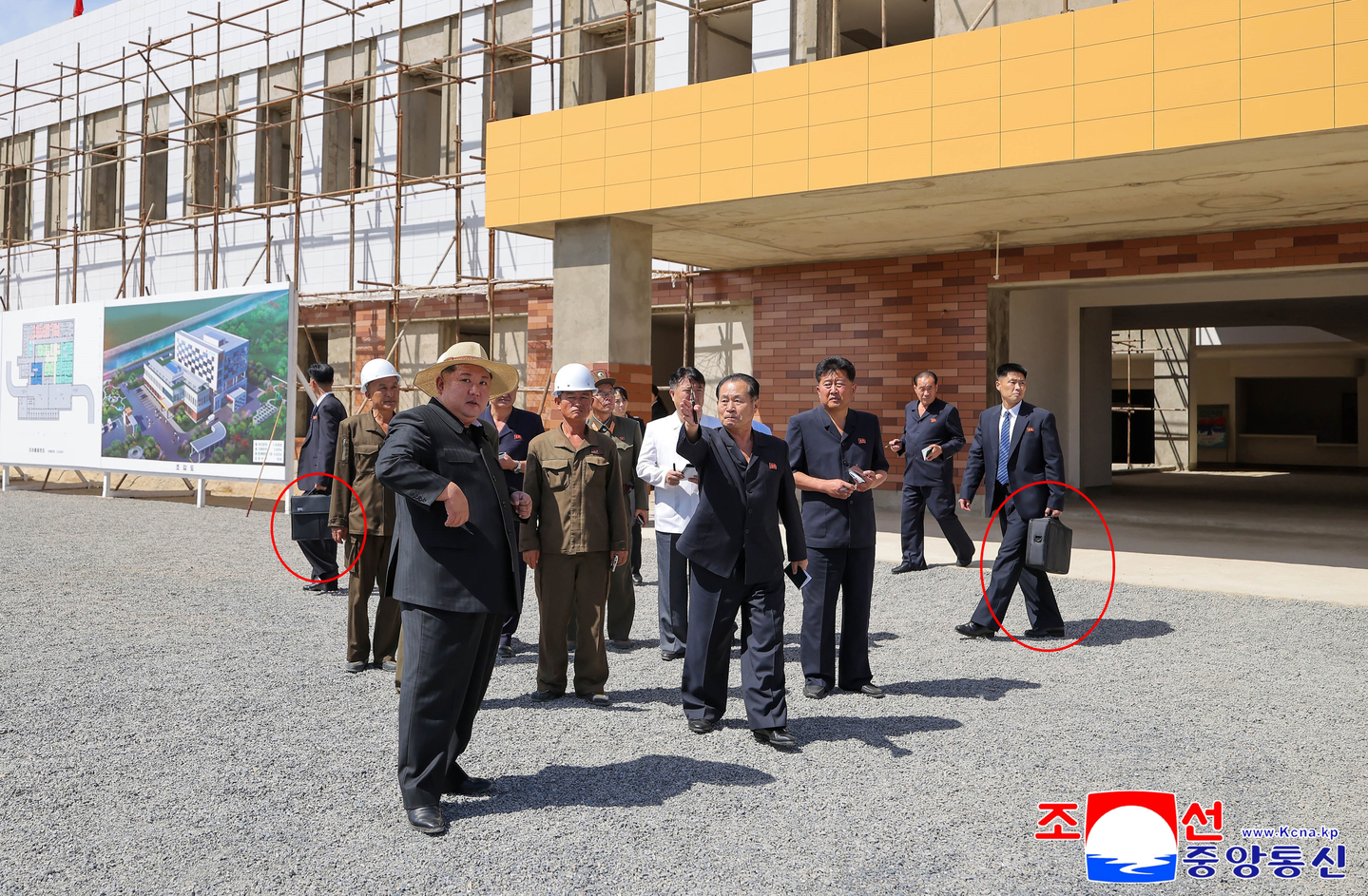 The photograph shows the North's leader Kim Jong-un, surrounded by his bodyguards holding black suitcases on Sept. 13, 2025, during his inspection of a regional hospital under construction the previous day. [KOREAN CENTRAL NEWS AGENCY] 