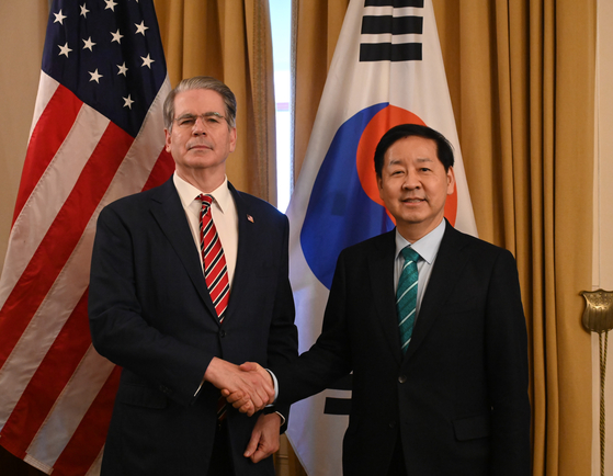 Korea's Finance Minister Koo Yun-cheol, right, and U.S. Treasury Secretary Scott Bessent shake hands at a ministerial meeting held in Washington on Jan. 12. [MINISTRY OF ECONOMY AND FINANCE]