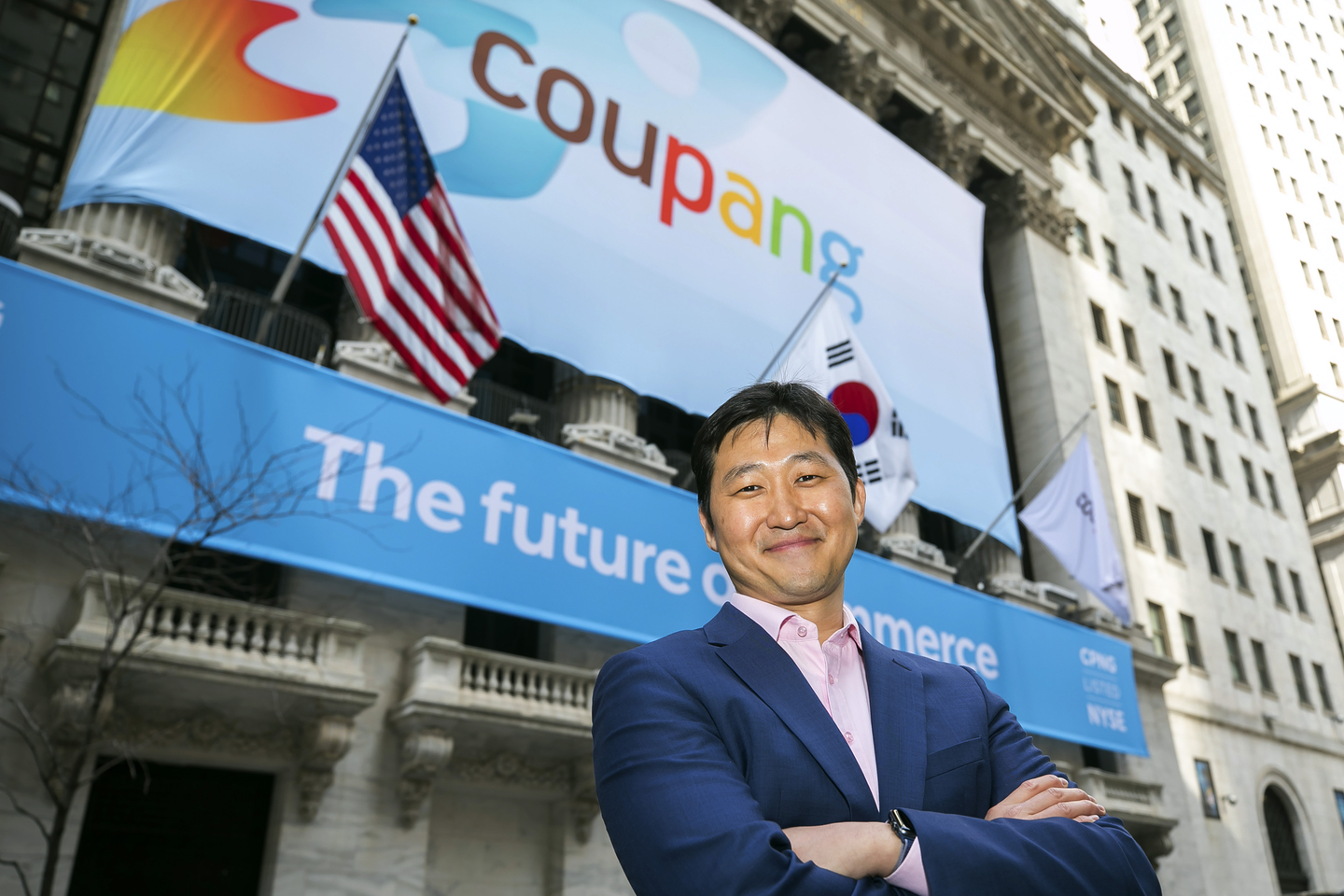 In this photo provided by the New York Stock Exchange, Coupang Founder and CEO Bom Kim poses in front of the New York Stock Exchange facade before his company's IPO on March 11, 2021. [AP/YONHAP]