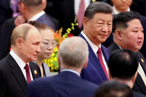 Chinese President Xi Jinping, Russian President Vladimir Putin and North Korean leader Kim Jong-un arrive for a reception marking the 80th anniversary of the end of World War Two, at the Great Hall of the People in Beijing on Sept. 3, 2025. From center left: Vladimir Putin, Xi Jinping and Kim Jong-un. [REUTERS/YONHAP]  