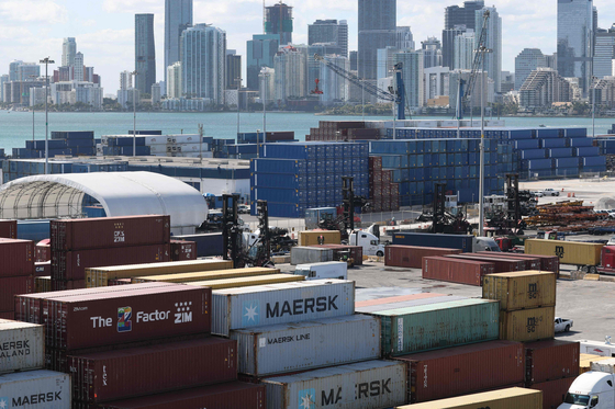 Shipping containers are stacked at Port Miami as workers handle cargo in Miami, Florida on Jan. 20. [AFP/YONHAP]