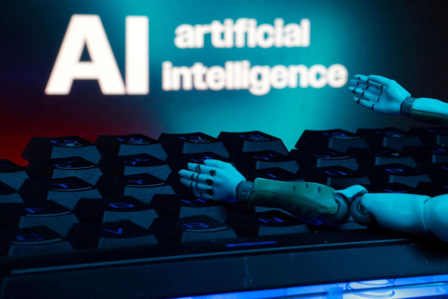 A message reading ″AI artificial intelligence,” a keyboard and robot hands are seen in this illustration taken on Jan. 27, 2025. [REUTERS/YONHAP]