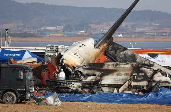 Debris of a Jeju Air passenger plane that collided with a perimeter wall after crash-landing at Muan International Airport in South Jeolla on Dec. 29. [YONHAP]