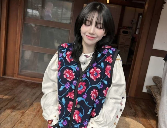 Karina, a member of girl group aespa, wears a floral vest commonly associated with grandmothers in Korea in this post uploaded to the singer's Instagram. [SCREEN CAPTURE]