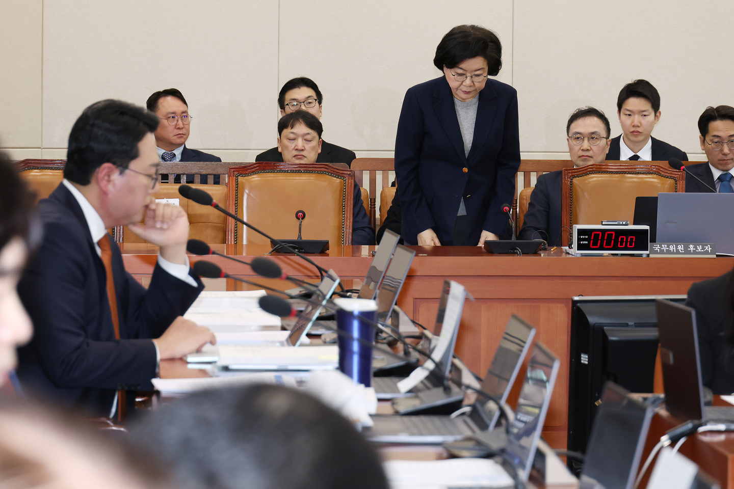 Lee Hye-hoon, the nominee for the first minister of the to-be-established Ministry of Planning and Budget, standing, is seen bowing during her confirmation hearing at the National Assembly in Yeouido, western Seoul, on Jan. 23. [NEWS1]