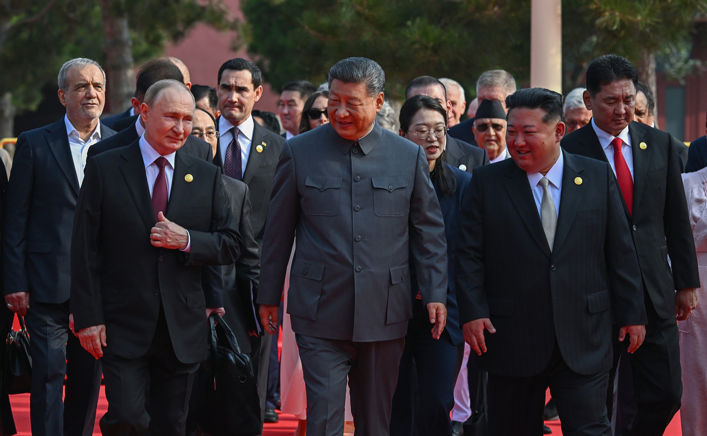 North Korean leader Kim Jong-un, right on front row, Chinese President Xi Jinping, center, and Russian President Vladimir Putin, left on front row, walk shoulder to shoulder ahead of a military parade at Tiananmen Square on Sept. 3, 2025 in this photo released by [TASS/YONHAP]