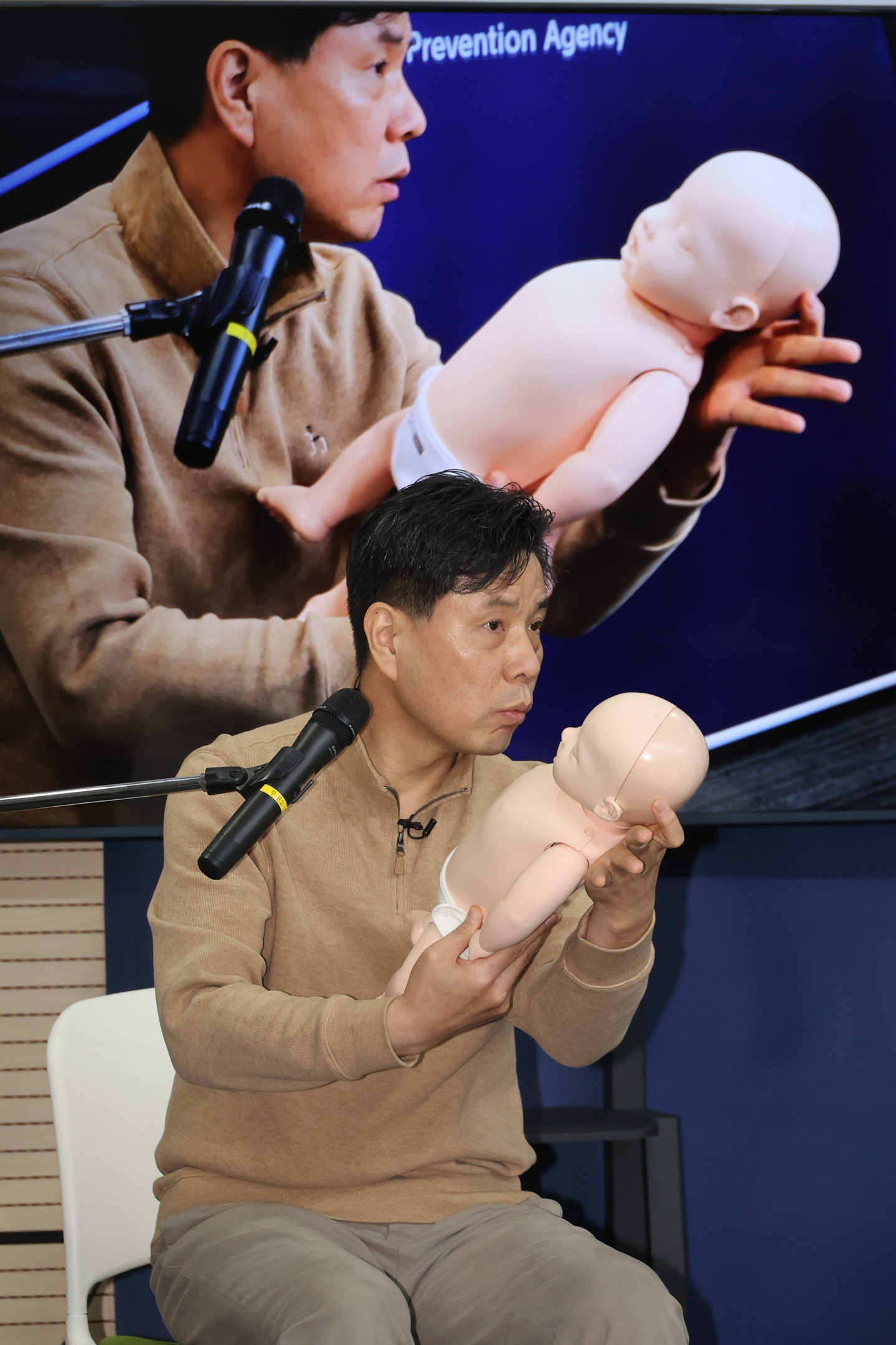 Lee Chang-hee, a professor of emergency medical services at Namseoul University, demonstrates the two-thumb encircling hands technique for infant chest compressions in accordance with the revised cardiopulmonary resuscitation guidelines on Jan. 29. [YONHAP]