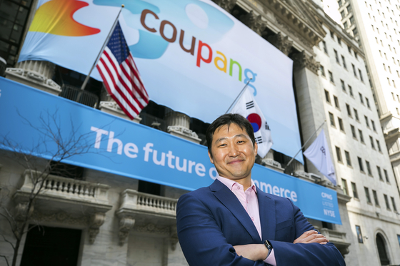 Coupang Founder and CEO Bom Kim poses in front of the New York Stock Exchange facade before his company's initial public offering on March 11, 2021. [AP]