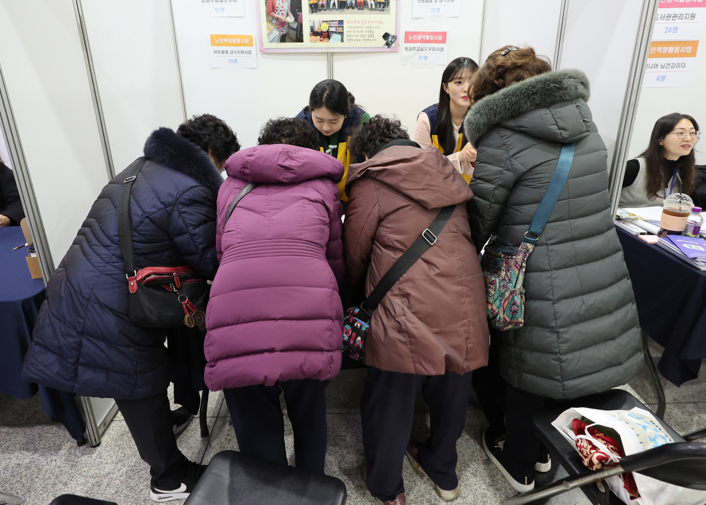 Visitors consult with officials to apply for jobs at an employment fair for older adults hosted by Mapo District in western Seoul on Dec. 10, 2025. [YONHAP]