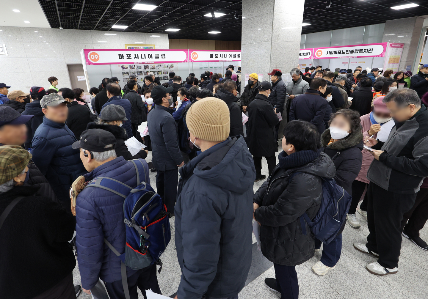 People line up to apply for jobs at an employment fair for older adults hosted by Mapo District at the Mapo District Office in western Seoul on Dec. 10, 2025. [YONHAP]