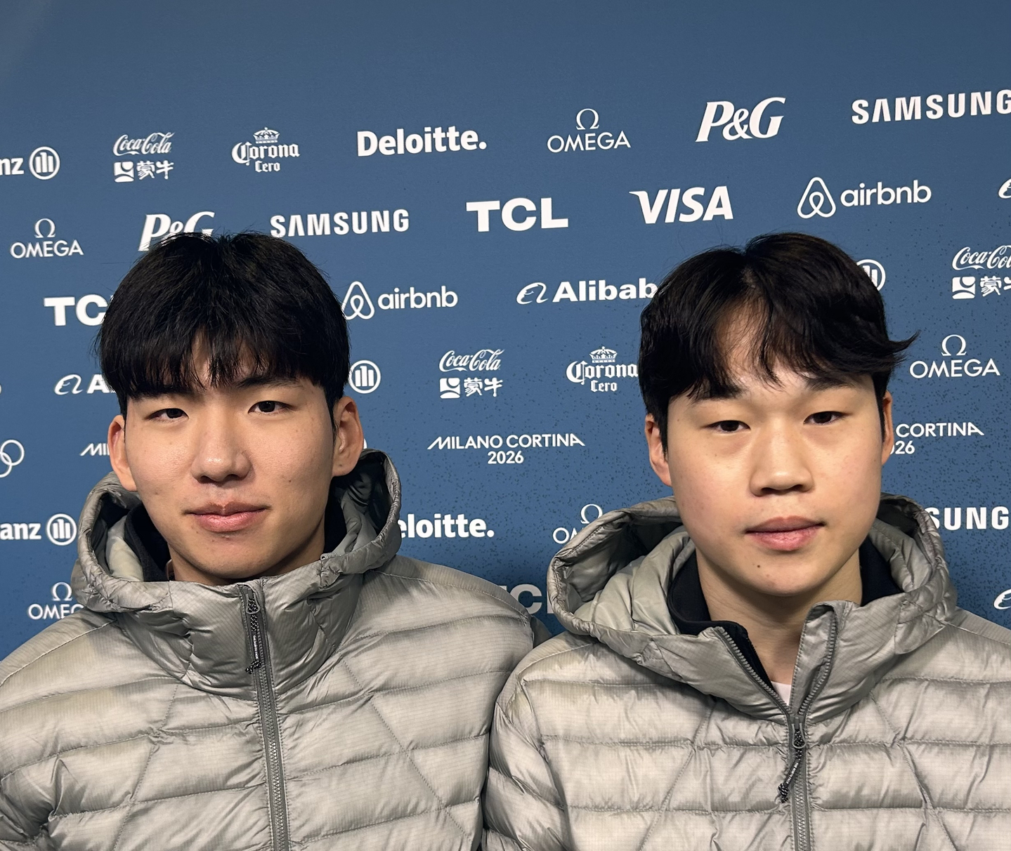 Korean speed skaters Chung Jae-won, left, and Cho Seung-min pose for photos after a training session for the 2026 Winter Olympics at Milano Speed Skating Stadium in Milan on Feb. 2. [YONHAP]