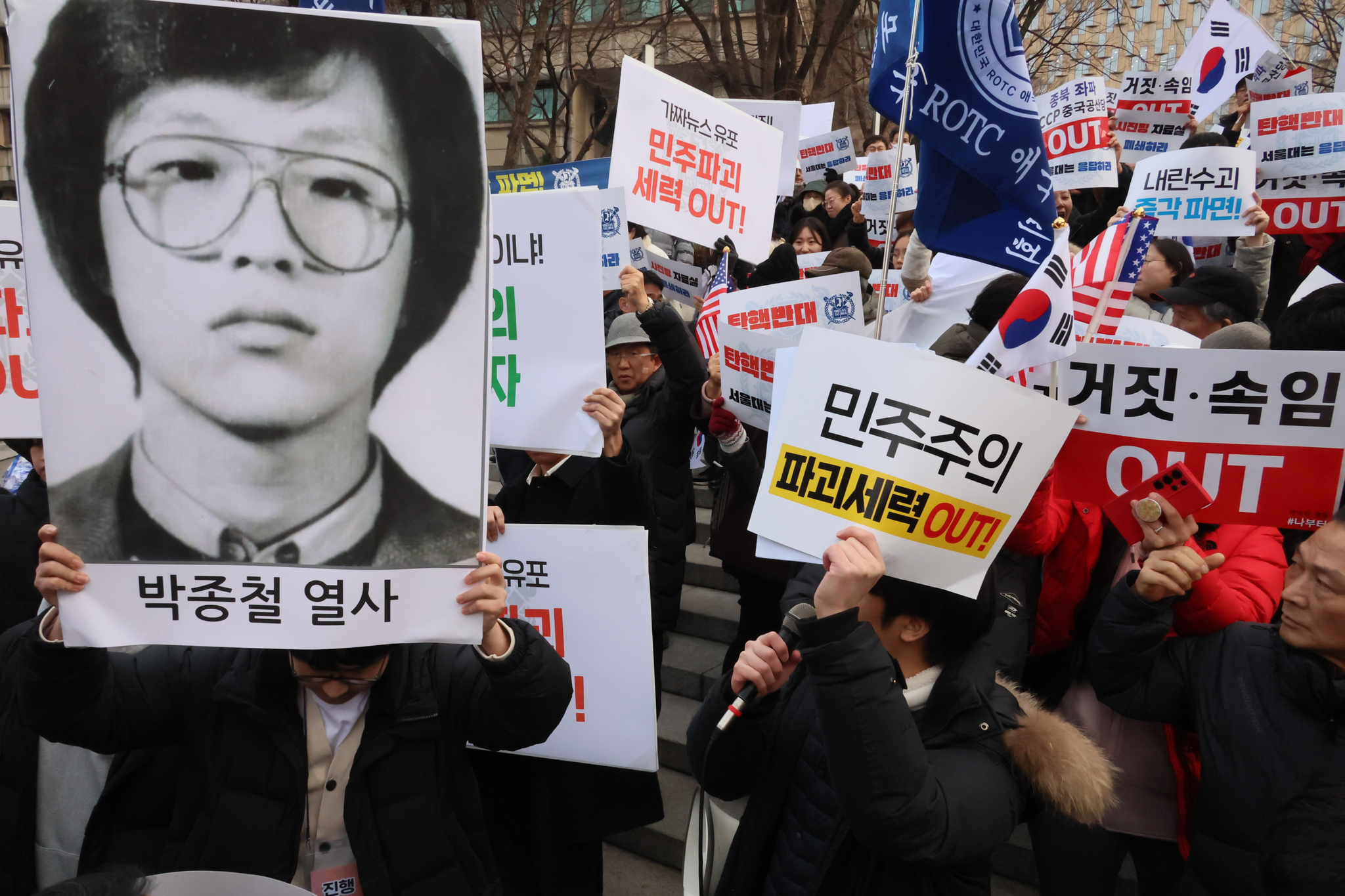 A protester in support of President Yoon Suk Yeol's impeachment, left, holds up a picture of democracy activist Park Jong-chul during a rally at Seoul National University in Gwanak District, southern Seoul, on Feb. 15, 2025. Park, a Seoul National University alumni, was killed in January 1987 while protesting the Chun Doo Hwan regime. [YONHAP]