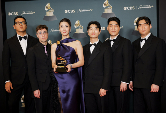 The producers of the soundtrack for ″KPop Demon Hunters″ (2025) pose with the Best Song Written For Visual Media award for ″Golden″ during the 68th Annual Grammy Awards in Los Angeles, California, on Feb. 1. [REUTERS/YONHAP]