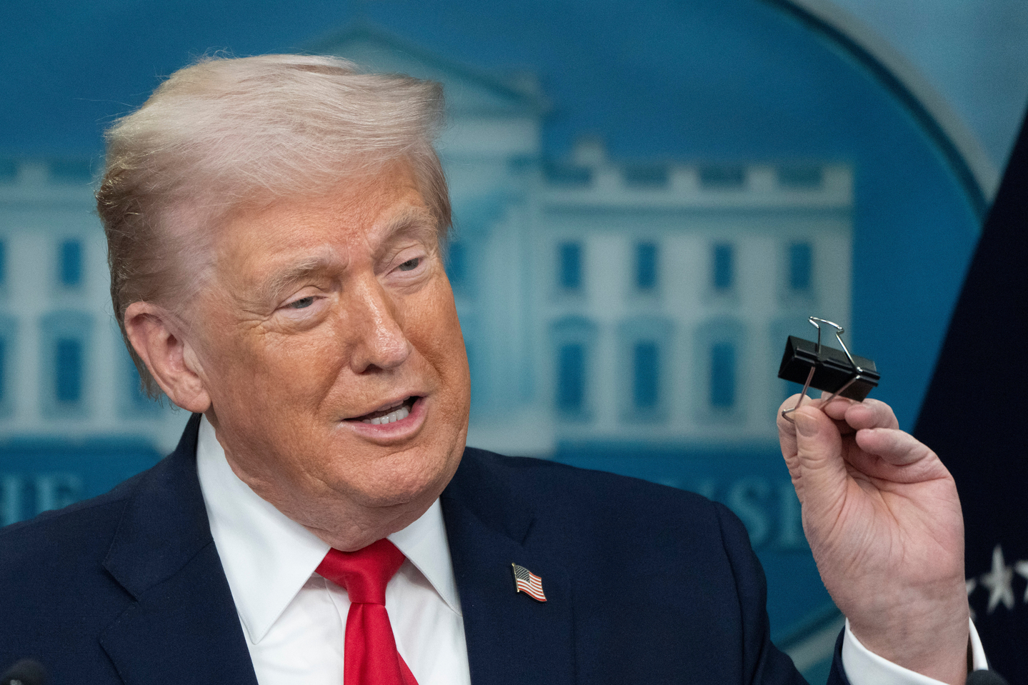 U.S. President Donald Trump holds a binder clip as he speaks during a press briefing at the White House in Washington on Jan. 20. [AP/YONHAP] 