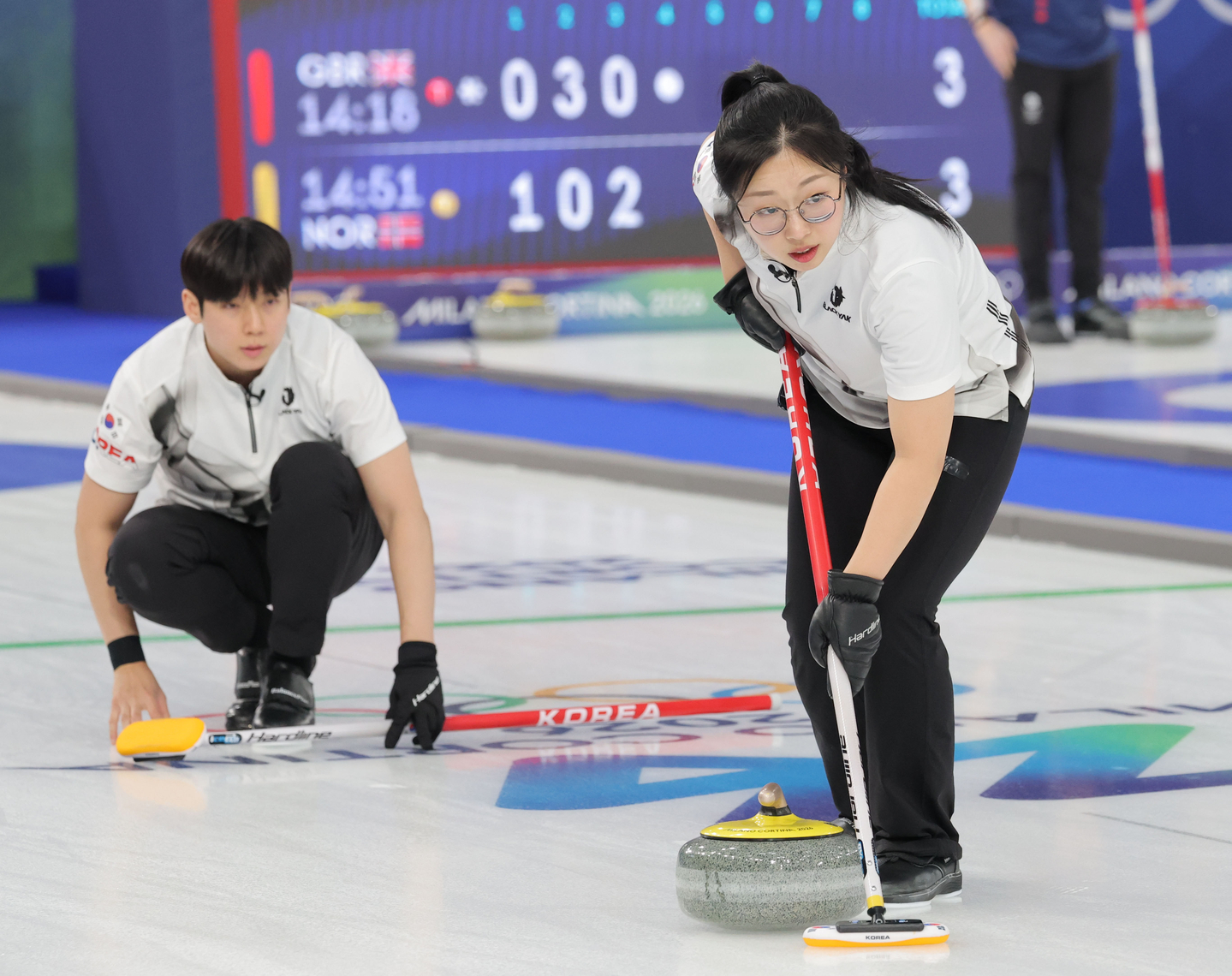 Jeong Yeong-seok, left, and Kim Seon-yeong of Korea compete against Sweden in their first round-robin match of the mixed doubles curling tournament of the 2026 Winter Olympics at Cortina Curling Olympic Stadium in Cortina d'Ampezzo, Italy, on Feb. 4. [YONHAP] 