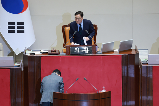 People Power Party leader Jang Dong-hyeok, bottom, bows to National Assembly Speaker Woo Won-shik after ending his filibuster at the National Assembly in western Seoul on Dec. 23, 2025. [YONHAP]  