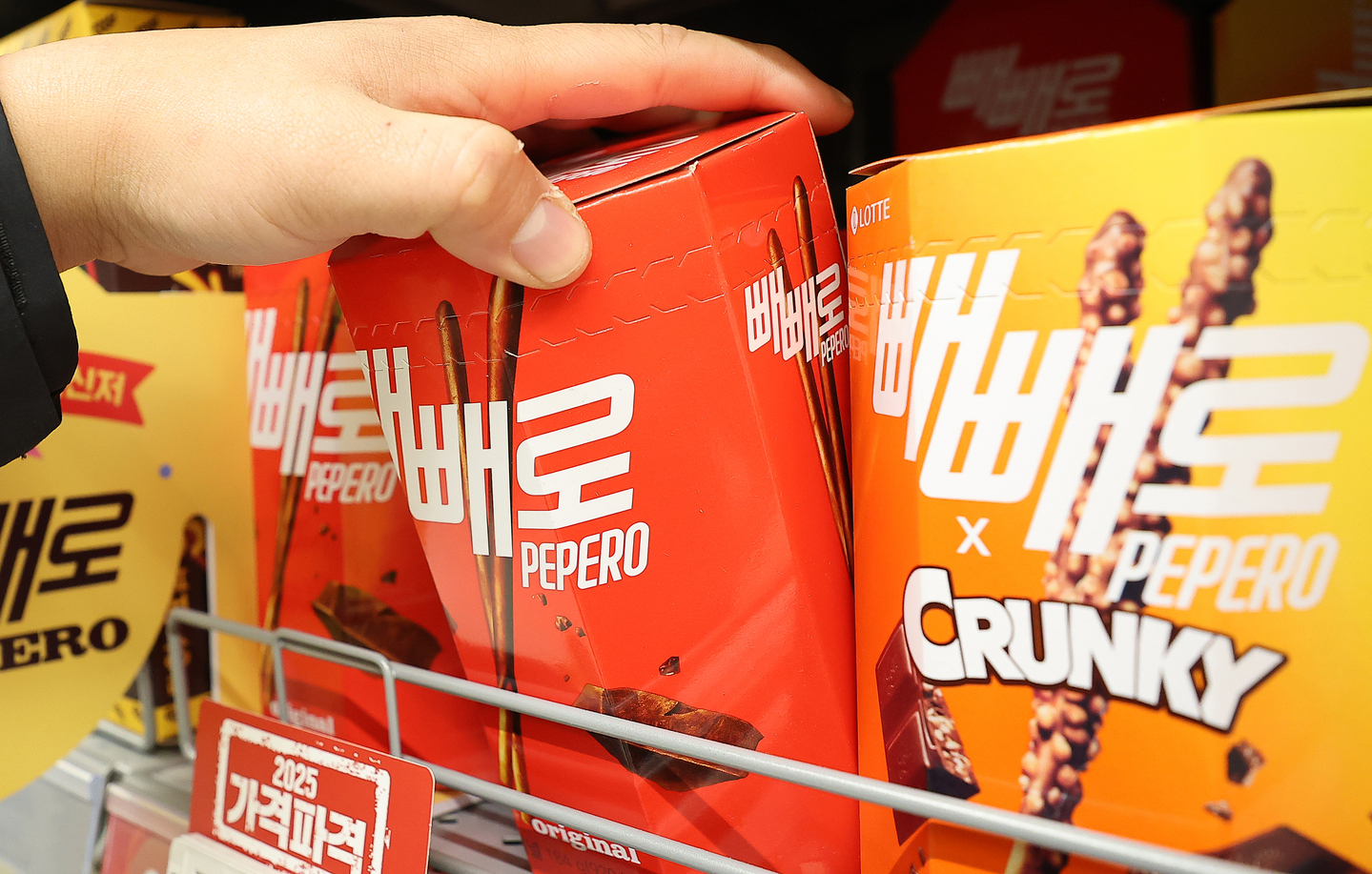 A shopper is seen selecting Pepero products, manufactured by Lotte Wellfood, at a large supermarket in Seoul on Feb. 6, 2025. [NEWS1] 