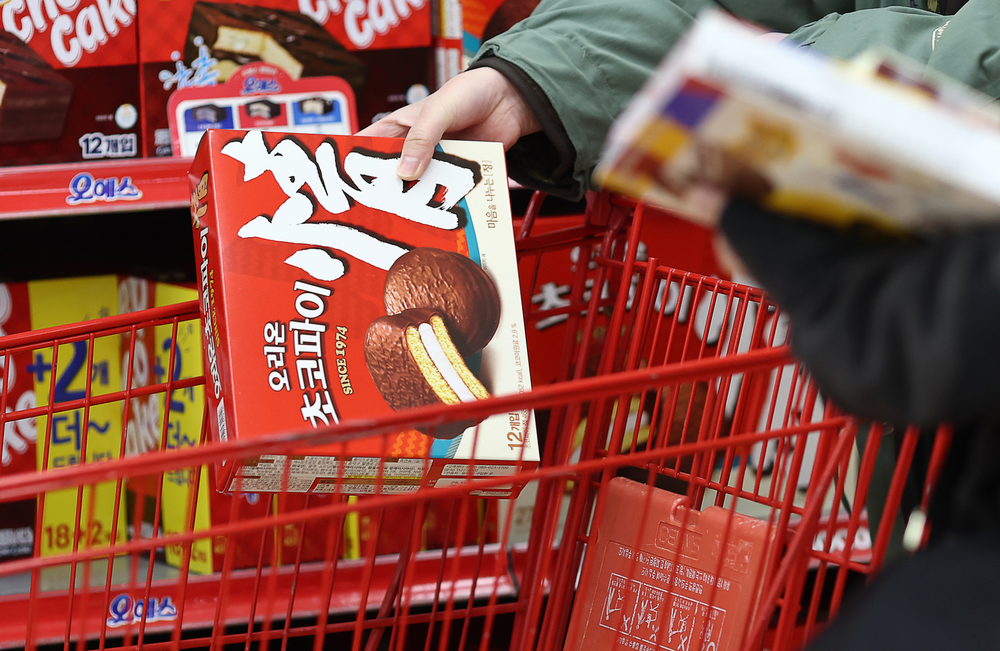 A shopper selects Orion Choco Pie products at a large supermarket in Seoul on Oct. 29, 2025. [YONHAP] 