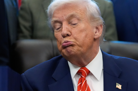 U.S. President Donald Trump listens before signing a spending bill in the Oval Office of the White House in Washington on Feb. 3. [AP/YONHAP]