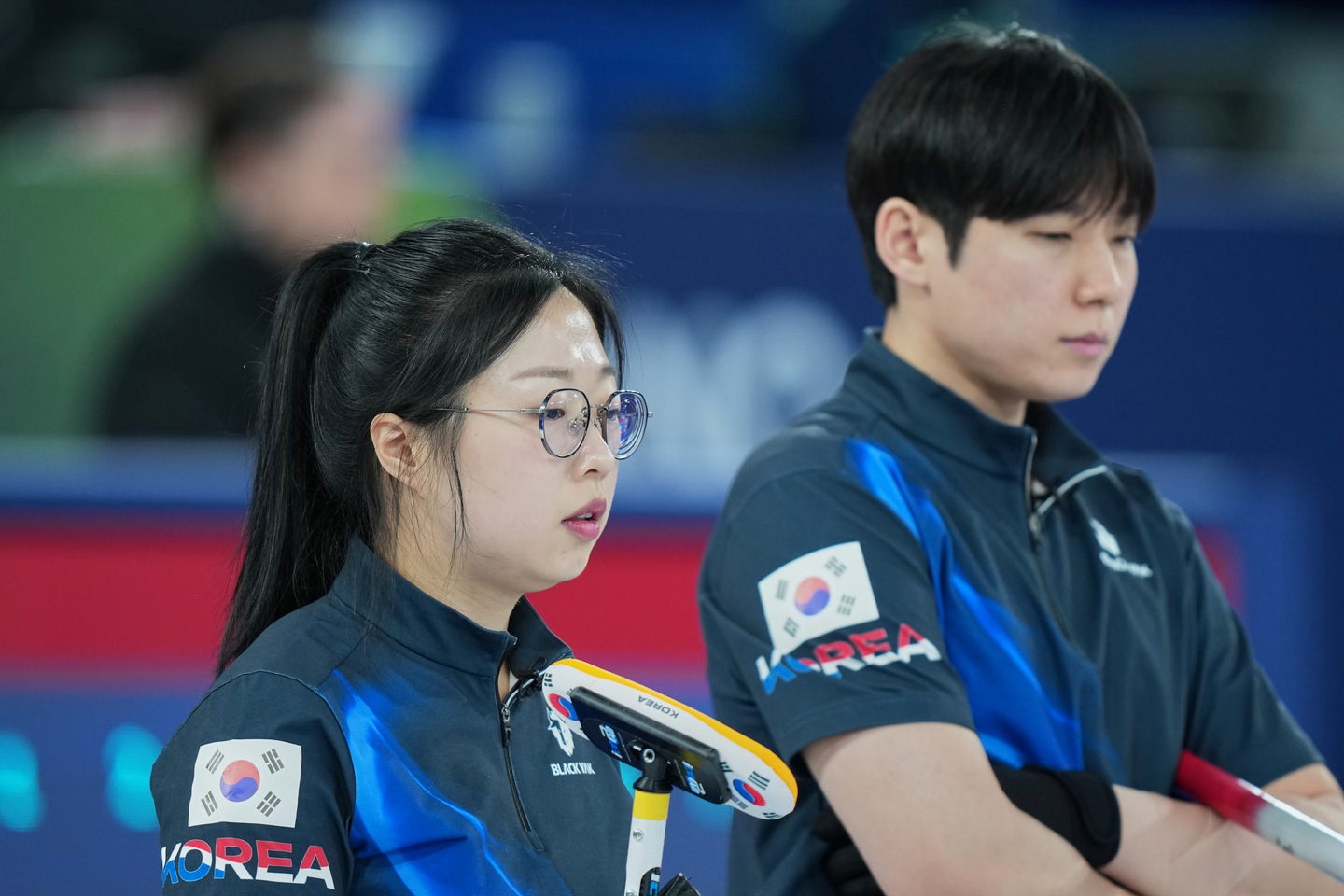 Korea's Kim Seon-yeong, left, and Jeong Yeong-seok compete during the mixed doubles round robin phase of the curling competition against Britain at the 2026 Winter Olympics, in Cortina d'Ampezzo on Feb. 6. [AP/YONHAP]