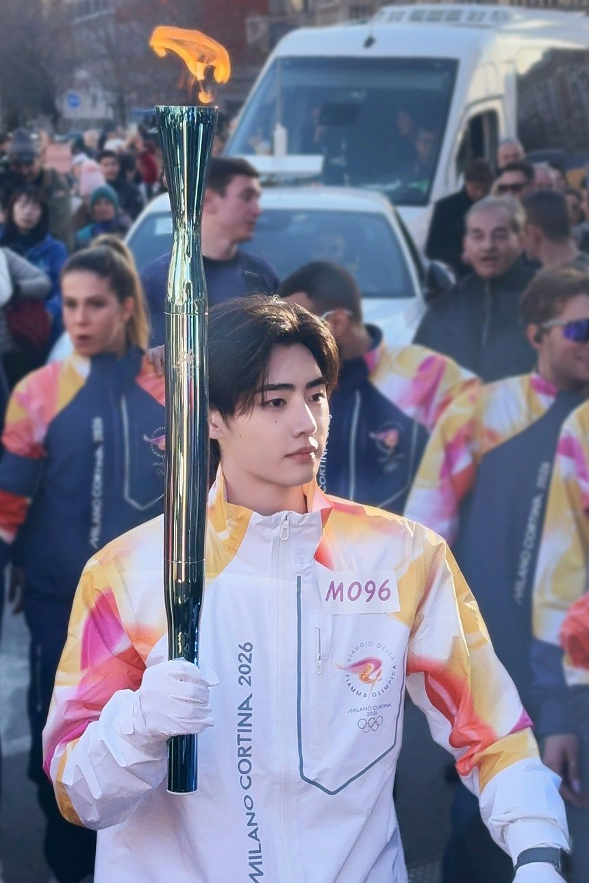 Sunghoon of K-pop group Enhypen holds the Olympic torch for the Milano Cortina Winter Olympics in Milan, Italy, on Feb. 5. [BELIFT LAB]