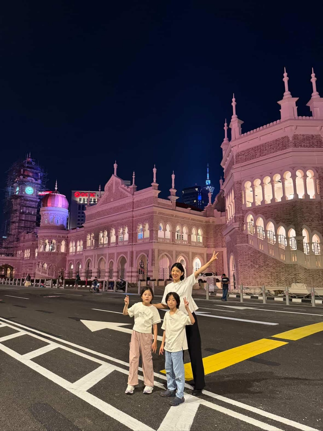 Park Chan-mi, a 41-year-old mother, poses for a photo with her twin children in Bangunan Sultan Abdul Samad, a historic building in Kuala Lumpur, Malaysia, on Jan. 17. [PARK CHAN-MI]