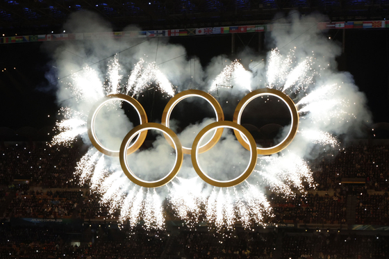 Fireworks burst from around the Olympic rings at the opening ceremony of the 2026 Milan-Cortina Winter Olympics held at the San Siro stadium in Milan on Feb. 6. [KIM JONG-HO]