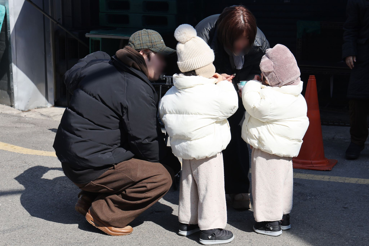 A family talks with each other on a street in Seoul on Feb. 23, 2025. [YONHAP]