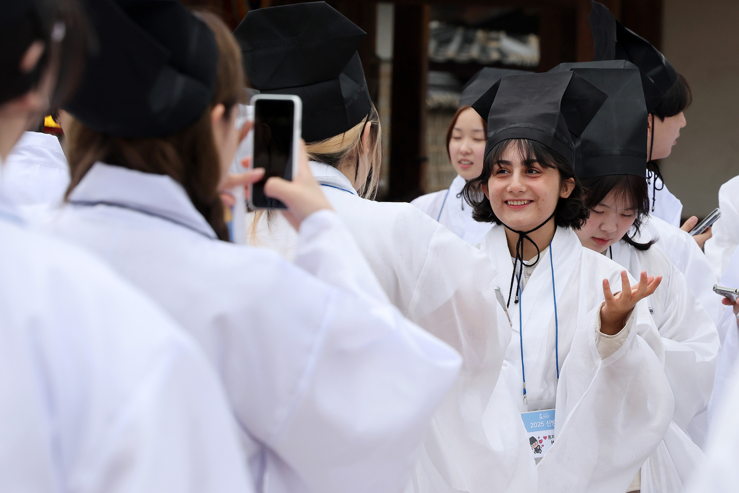 A student takes a photo while wearing the traditional attire of a Confucian scholar from the Joseon Dynasty (1392-1910) during a freshman orientation ceremony on March 16, 2025. [NEWS1] 