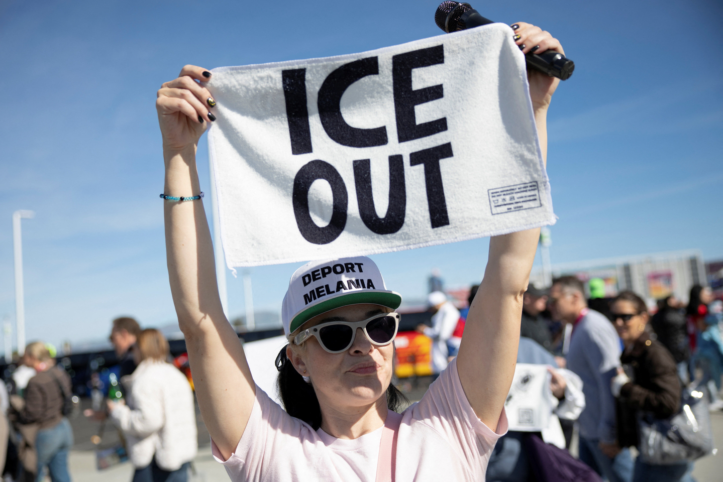 A protester holds a towel with a message against the immigration crackdown outside Levi's Stadium, the venue of Super Bowl LX, in Santa Clara, California, on Feb. 8.  [REUTERS/YONHAP]