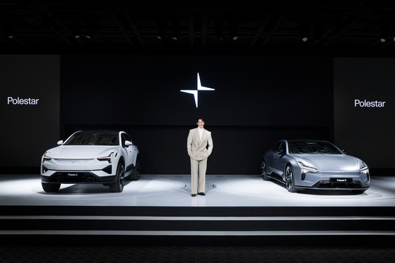 Actor Kim Woo-bin, the new brand ambassador for Polestar Korea, takes a photo with the Polestar lineups a media event on Feb. 11 in central Seoul. [POLESTAR KOREA] 