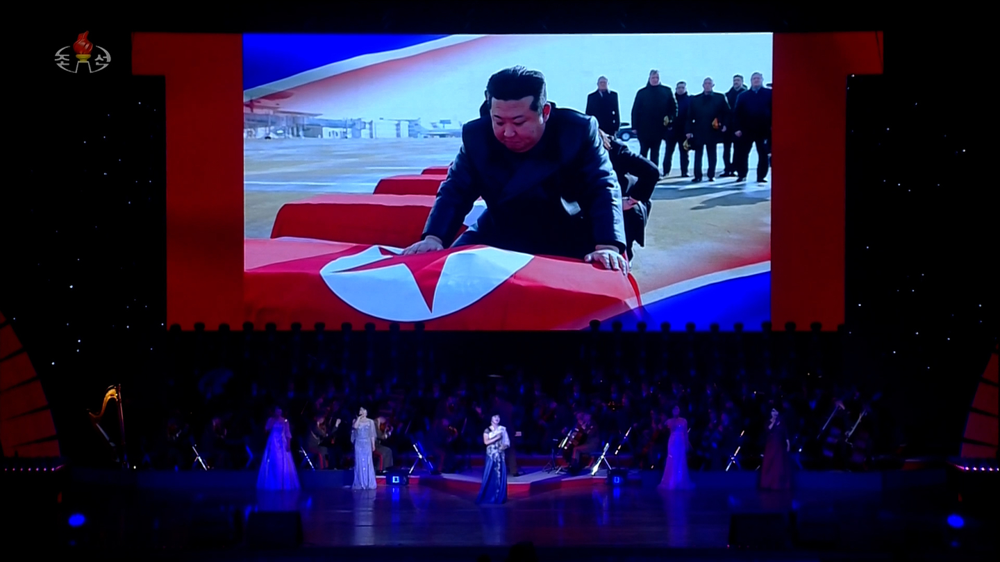 North Korea’s Korean Central Television on June 30, 2025, released footage showing a stage backdrop depicting North Korean leader Kim Jong-un mourning and touching the coffins of North Korean soldiers killed after being deployed to Russia, during a performance held the previous day at the April 25 House of Culture theater in Pyongyang. [YONHAP]