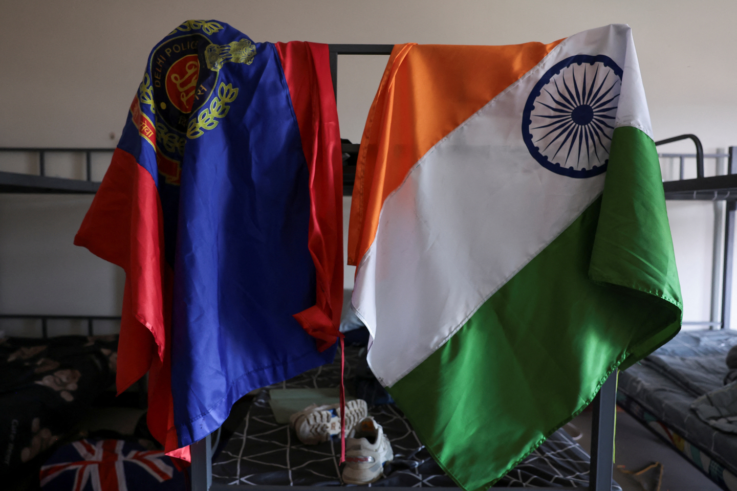 An Indian flag, right, and a Delhi police flag hang on a bunk bed in a dormitory inside a compound used for scam operations at the Chong Chom-O'Smach border crossing in Samraong, Oddar Meanchey Province, Cambodia, on Feb. 2. [REUTERS/YONHAP]