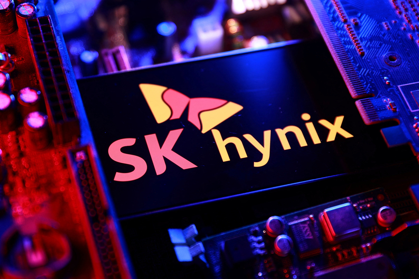 The SK hynix logo and a computer motherboard appear in this illustration taken on Aug. 25. [REUTERS/YONHAP]