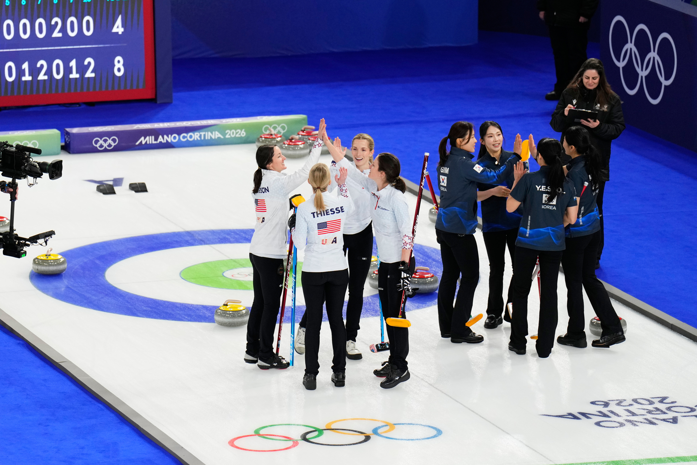 Team United States, left, celebrates after beating Korea during a women's curling round robin match at the 2026 Milan-Cortina Winter Olympics in Cortina d'Ampezzo, Italy on Feb. 12. [AP/YONHAP] 