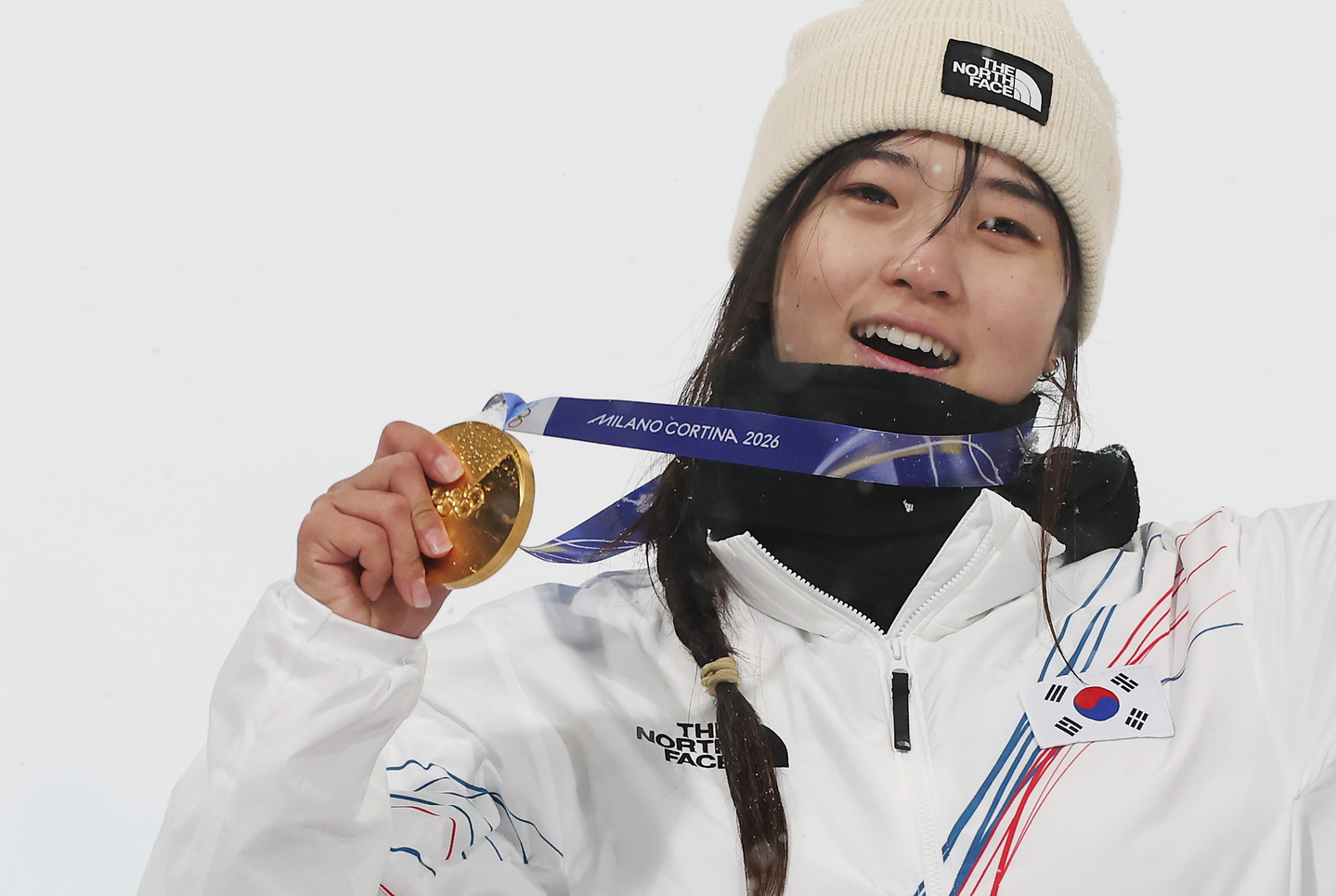 Snowboarder Choi Ga-on, who won the women’s snowboard halfpipe final at the Milan-Cortina 2026 Winter Olympics held at the Livigno Snow Park in Italy, tears up as she stands on the podium with the gold medal around her neck on Feb. 12.[YONHAP]
