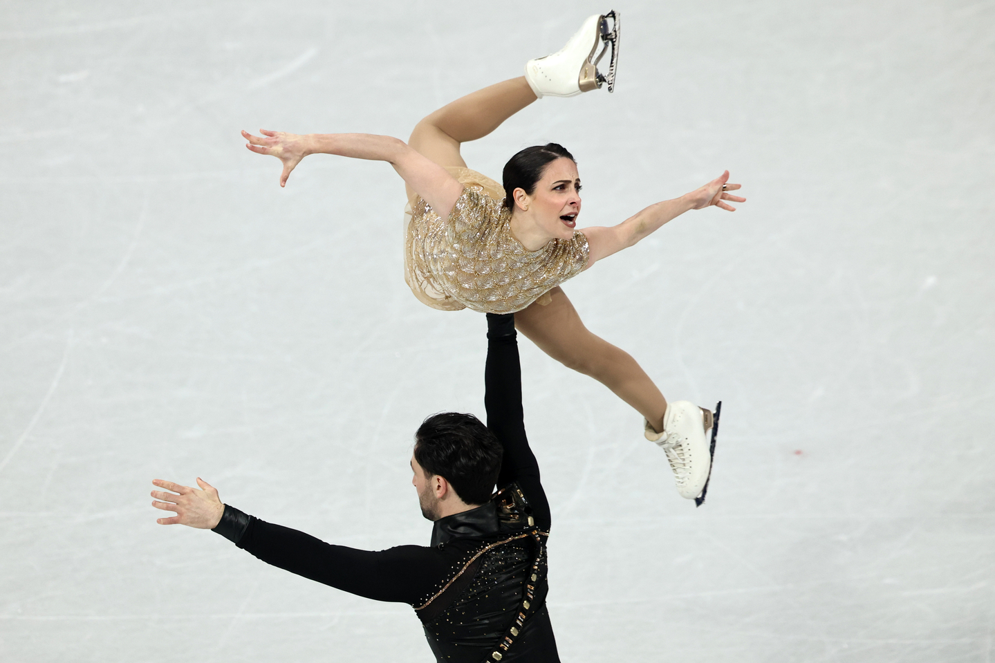 Canadian figure skater Deanna Stellato-Dudek is lifted by her partner, Maxime Deschamps, as they perform in the pair skating short program at the 2026 Milan-Cortina Winter Olympic Games on Feb. 15. [EPA/YONHAP]