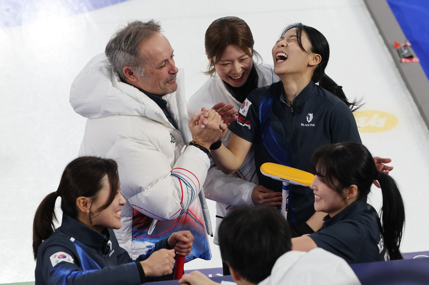 Members of the South Korean women’s curling team celebrate their 10-9 victory over China in the round-robin match at the 2026 Milan-Cortina Winter Olympics, held at the Cortina Curling Olympic Stadium in Cortina d’Ampezzo, Italy, on Feb. 16. [YONHAP]