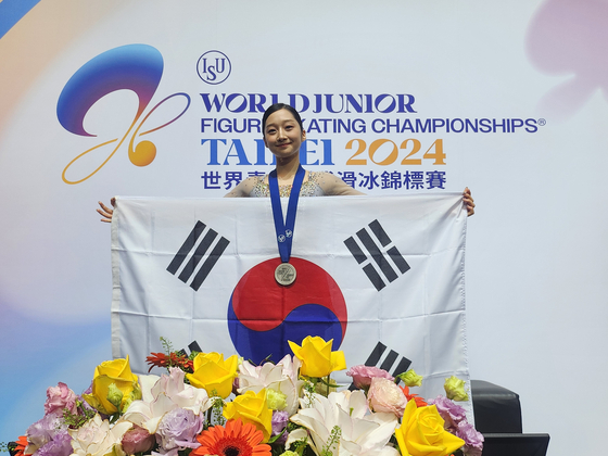 Shin Ji-a poses for a photograph while holding a Korean flag after claiming a silver medal at the 2024 world junior figure skating championship held in Taipei, Taiwan. [KOREA SKATING UNION]