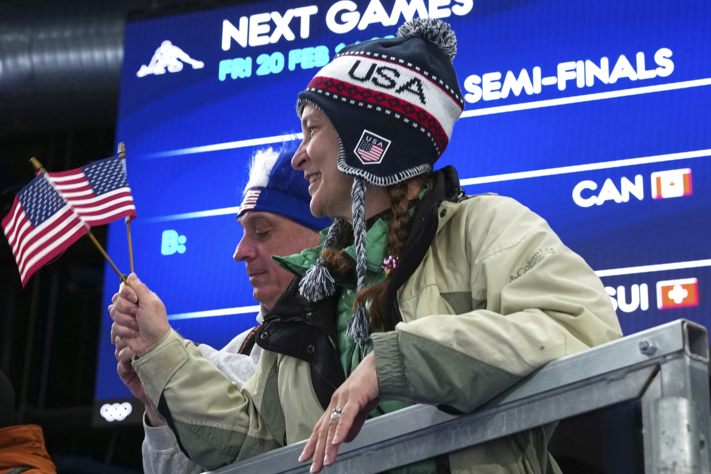 United States fans react after the women's curling round robin session against Switzerland, at the 2026 Winter Olympics, in Cortina, Italy, on Feb. 19. [AP/YONHAP]