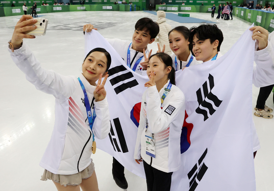 Shin Ji-a, bottom left, takes a selfie with other figure skaters on the national team after winning a gold medal in team events at the Gangwon 2024 Winter Youth Olympics held in Gangwon. [NEWS1]