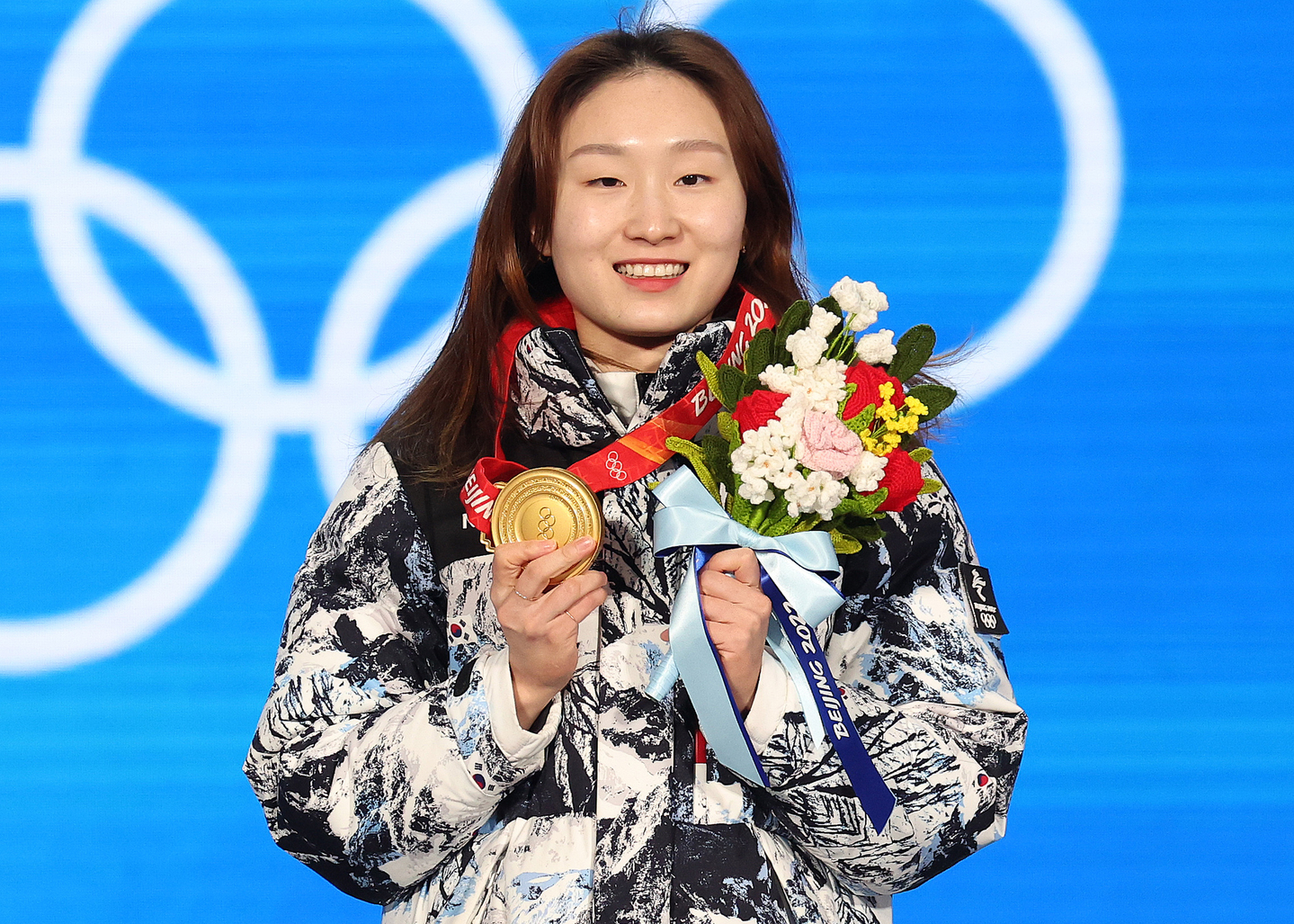 Short track speed skater Choi Min-jeong holds her gold medal on the podium during the medal ceremony on Feb. 17, 2022. Choi won her signature 1,500-meter event at the Beijing Winter Olympics. [NEWS1]