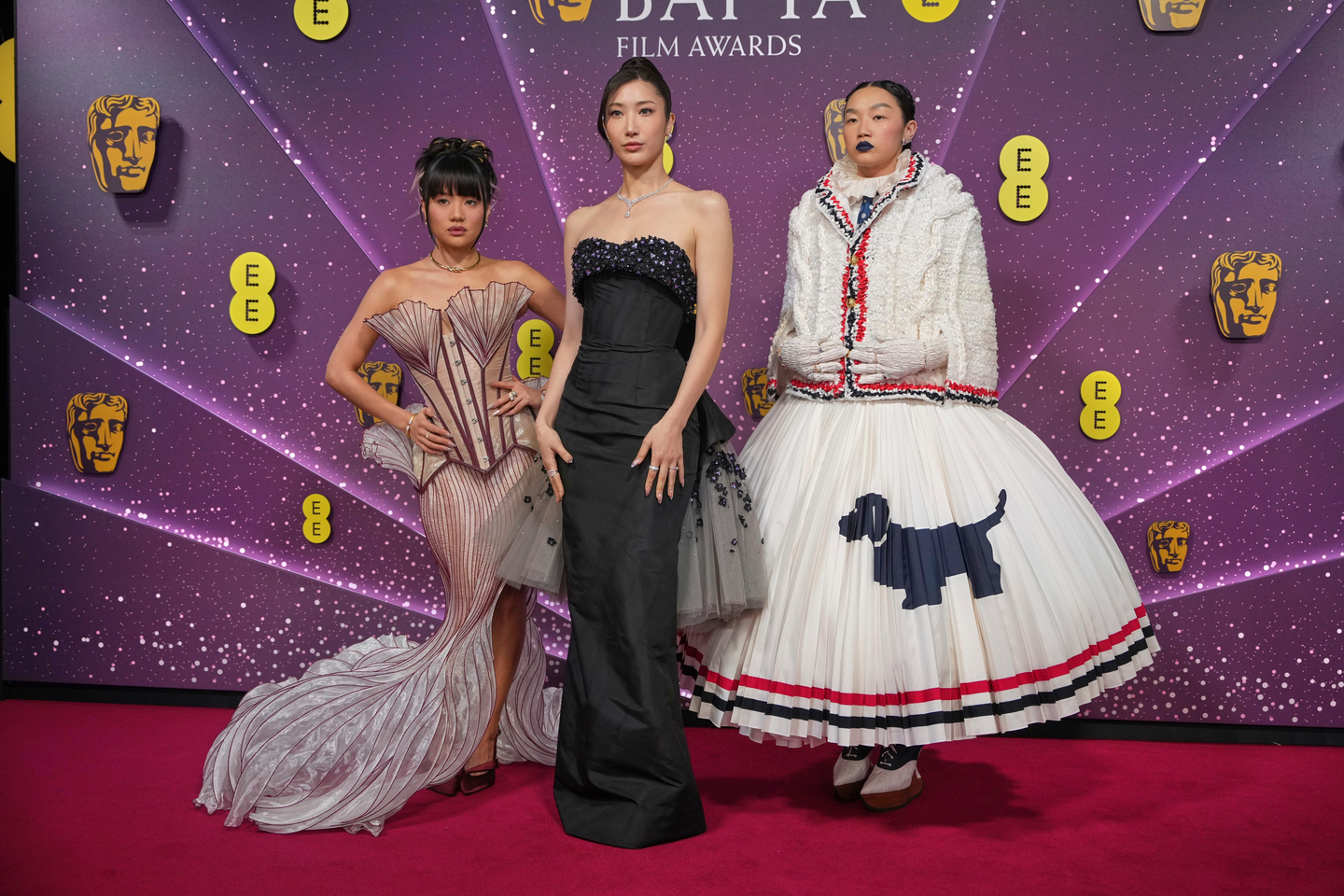 Ejae, left, Audrey Nuna and Rei Ami pose for photographers upon arrival at the 79th British Academy Film Awards in London, on Feb. 22. [AP/YONHAP]