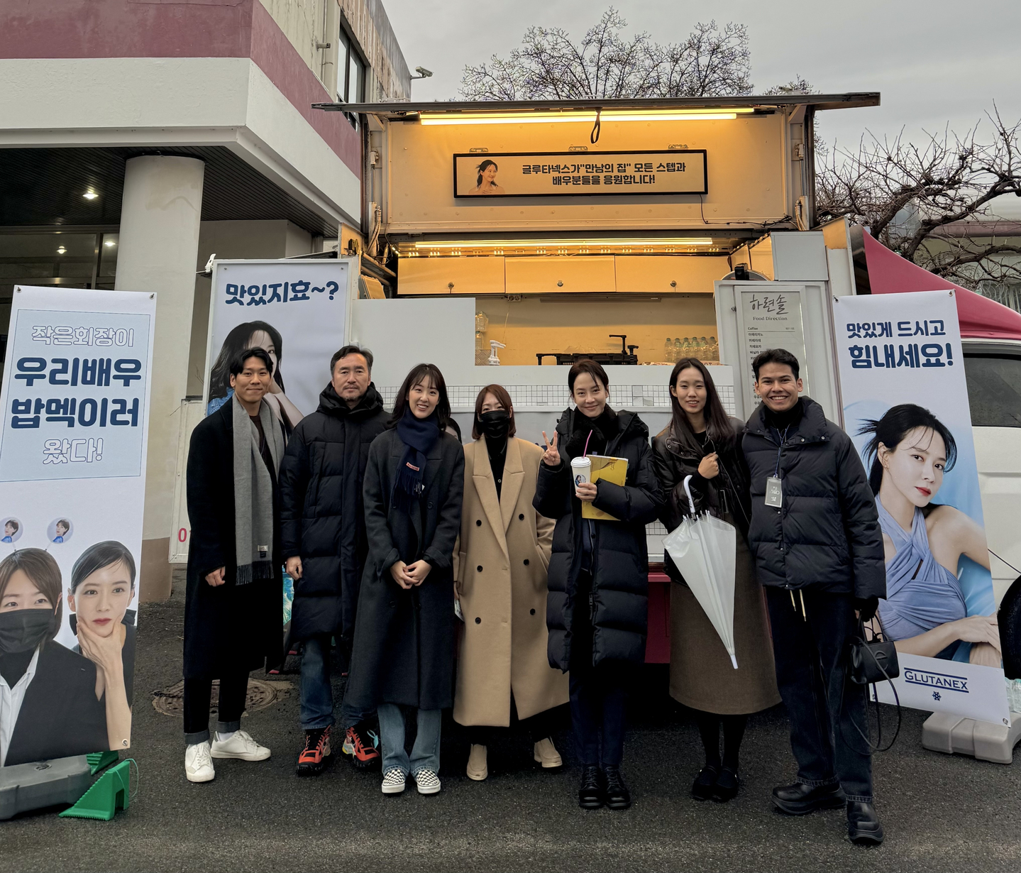 Muhammad Naufal Bin Omar, far right, poses for a photo with Glutanex's ambassador actor Song Ji-hyo, third from right, in front of a food truck prepared for the cast and crew of her upcoming film ″Home Behind Bars.″ [MUHAMMAD NAUFAL BIN OMAR]