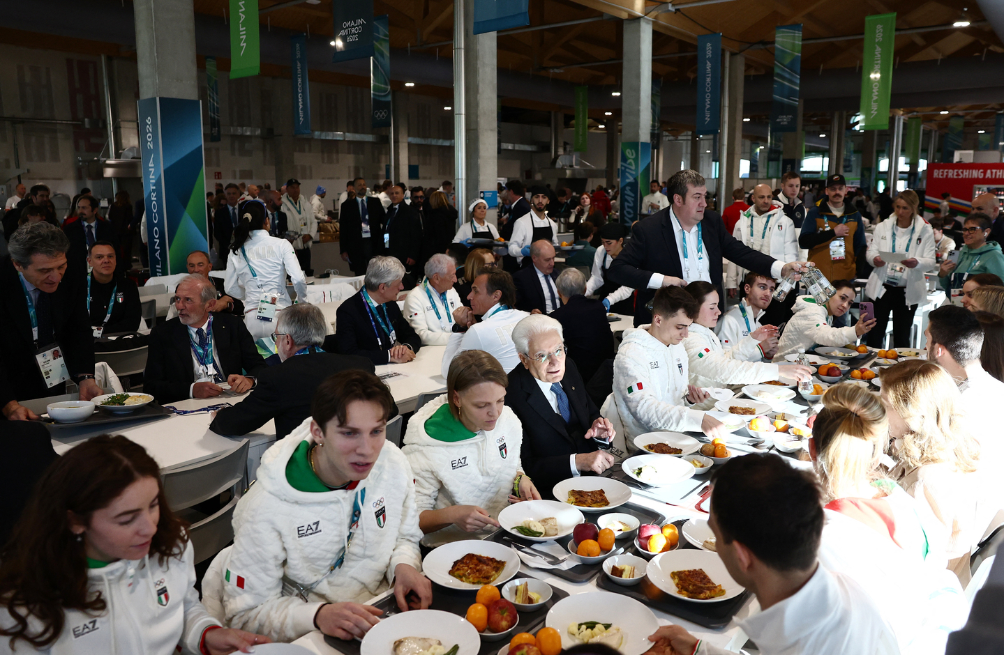 Italian President Sergio Mattarella eats with Italian athletes during a visit to the Olympic Village at the 2026 Milan-Cortina Winter Olympics in Milan on Feb. 5. [AP/YONHAP]