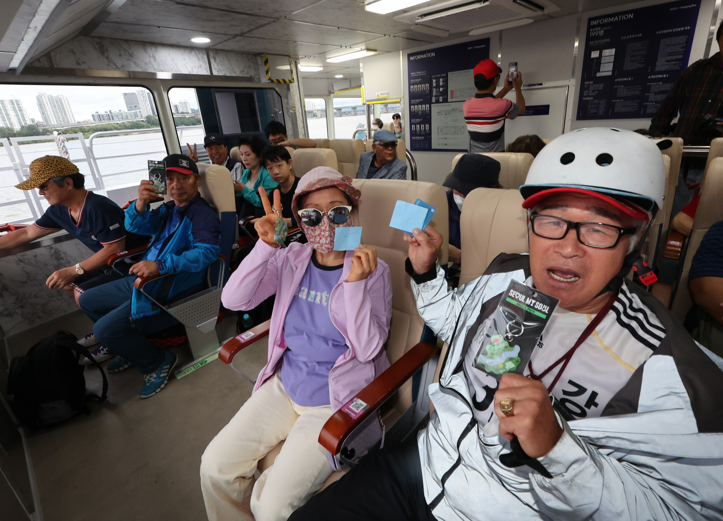 Passengers smile after boarding the Hangang Bus ferry on its opening day at Jamsil Pier in Songpa District, southern Seoul, on Sept. 18, 2025. [YONHAP]