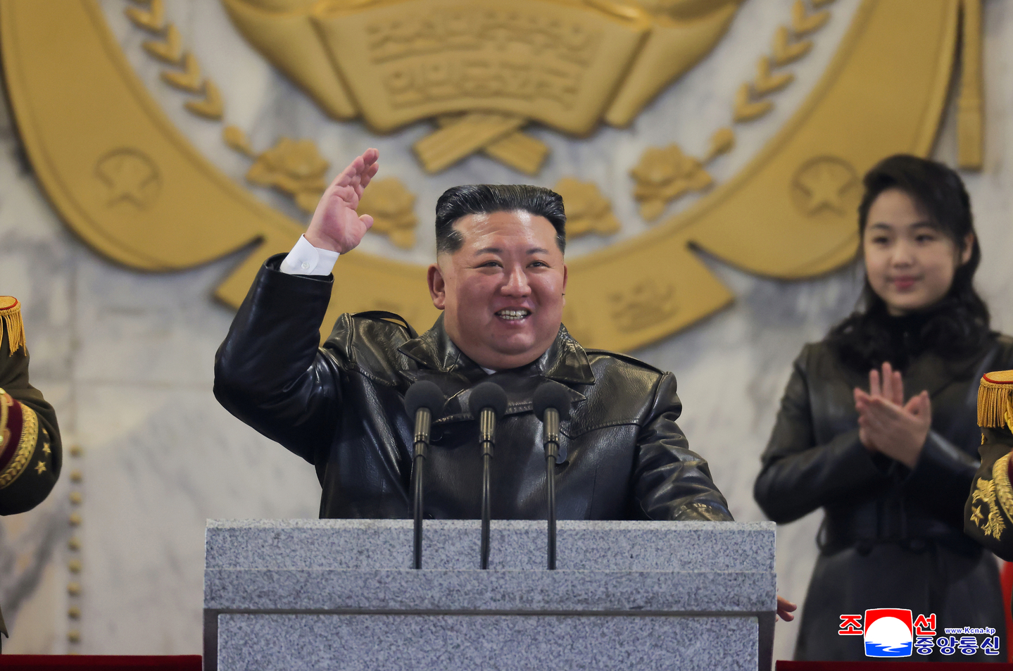 North Korean leader Kim Jong-un, center, is seen alongside his daughter Kim Ju-ae during a military parade marking the Ninth Party Congress of the Workers' Party at Kim Il Sung Square in Pyongyang on Feb. 25, in this photo carried by the state-run Korean Central News Agency. [YONHAP]