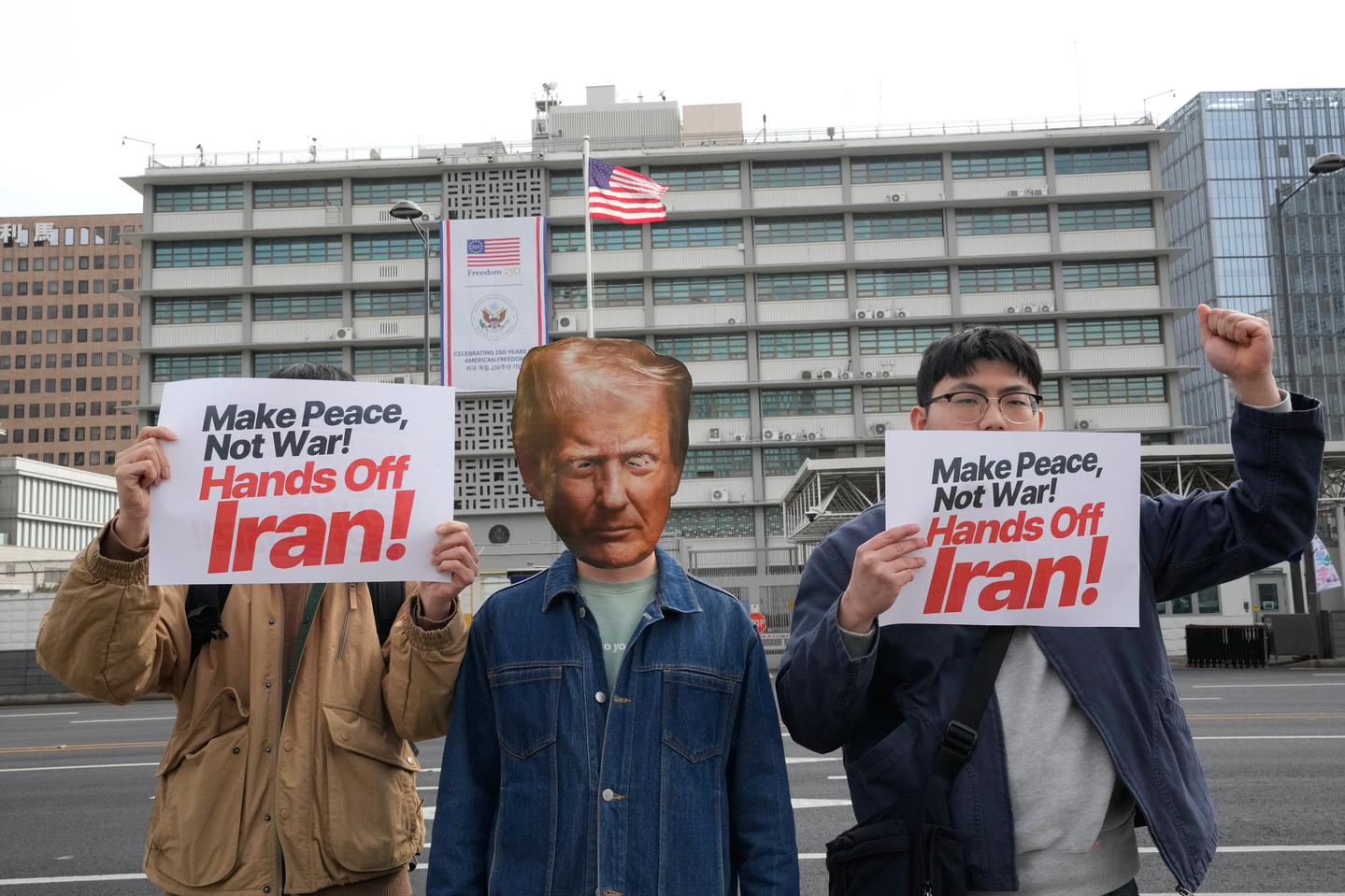 A protester wearing a mask of U.S. President Donald Trump attends a press conference denouncing the United States and Israel's attack on Iran, near the U.S. Embassy in Seoul on March 1. [AP/YONHAP]