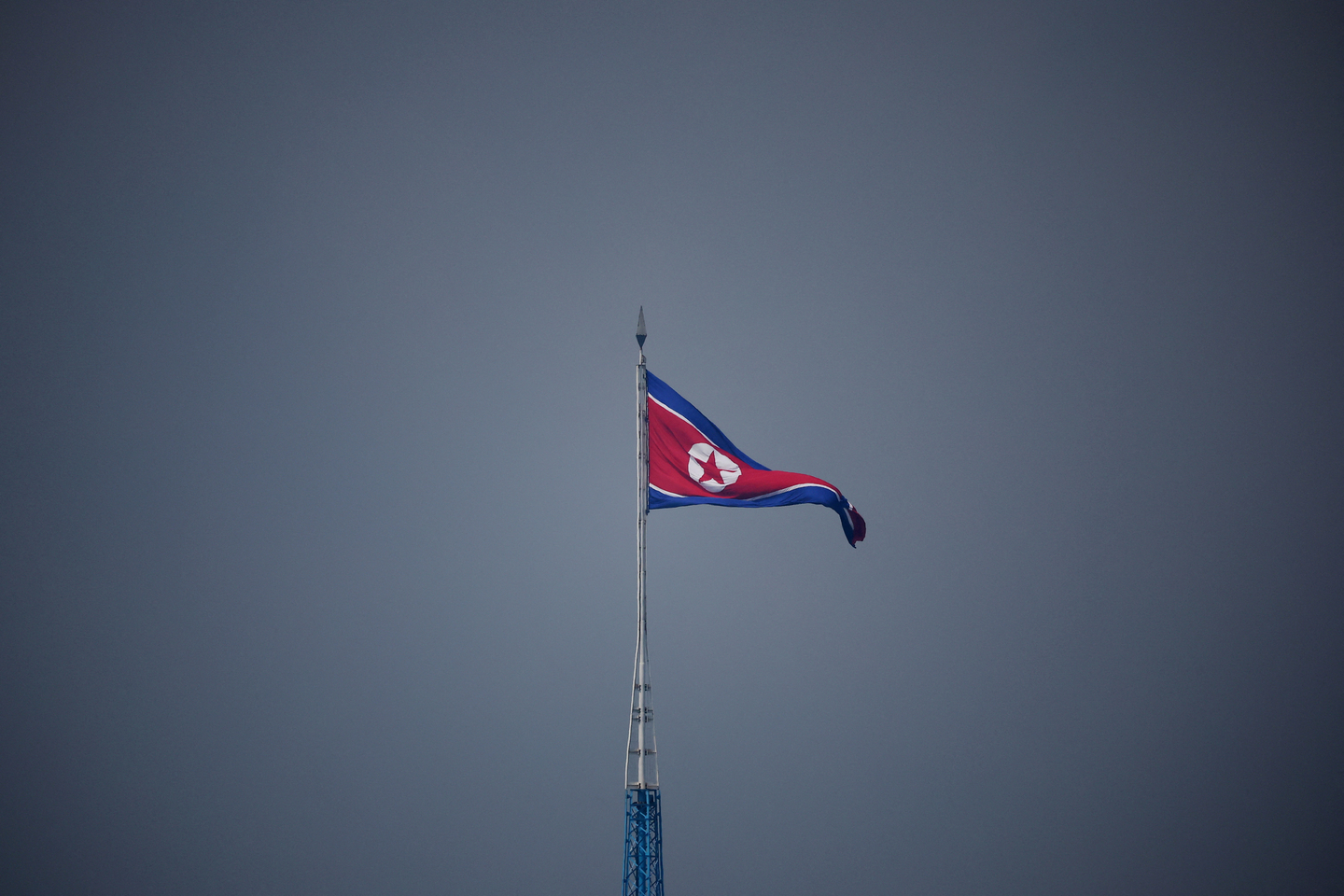 A North Korean flag flutters at the propaganda village of Gijungdong in North Korea, in this picture taken near the truce village of Panmunjom inside the demilitarized zone, separating the two Koreas, in South Korea on July 19, 2022. [REUTERS/YONHAP]